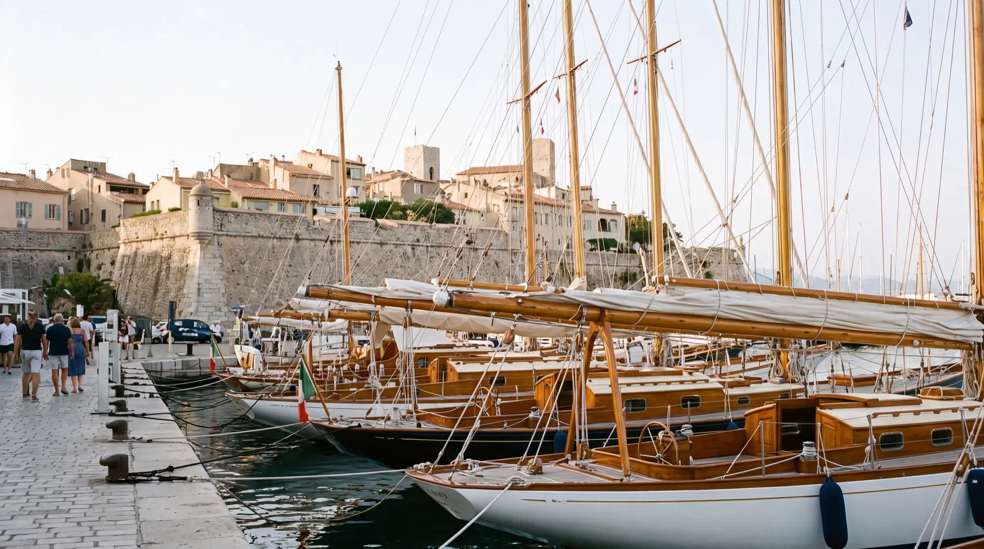 Classic wooden yachts moored in Port Vauban below the ramparts of Antibes