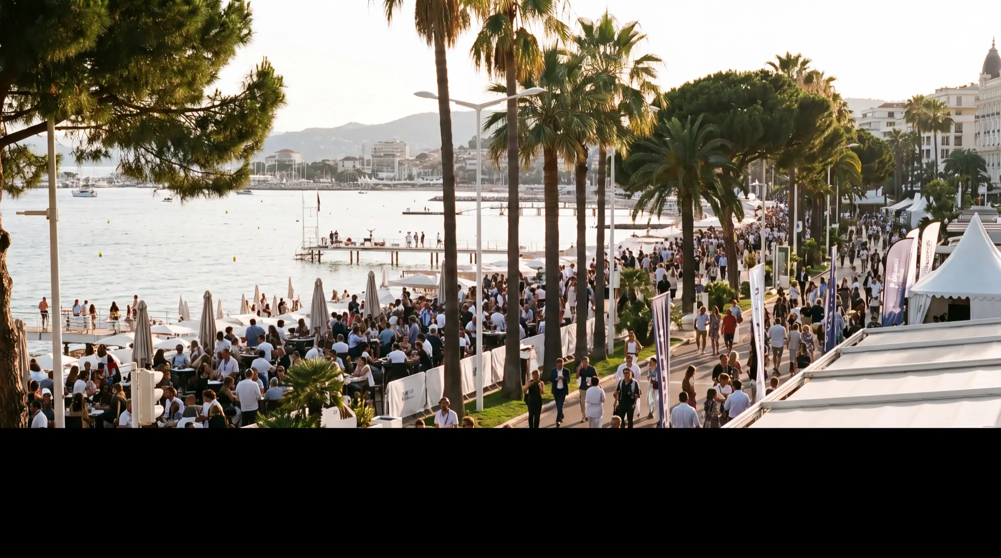 La Croisette in Cannes at the end of a June afternoon with busy terraces along the seafront