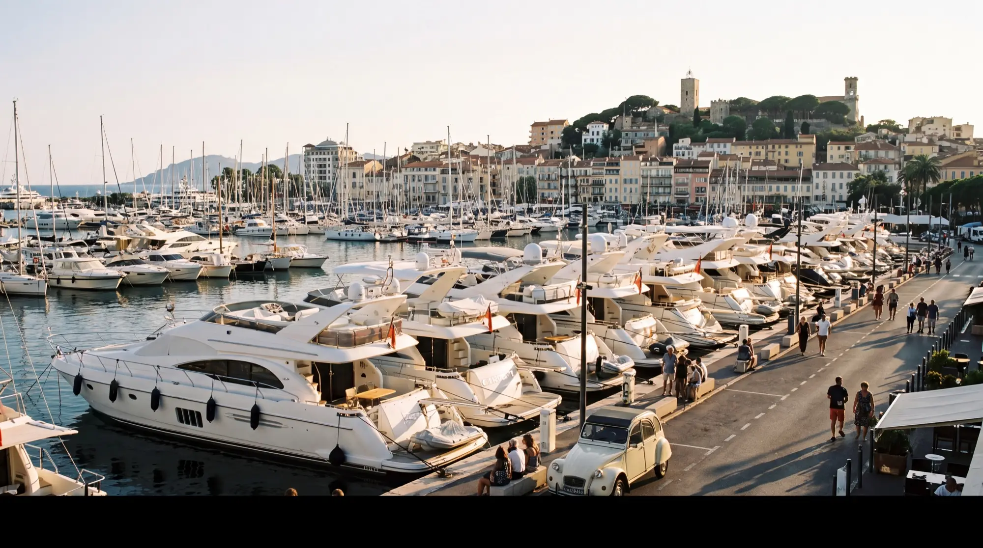 Yachts moored along the quay of the Vieux Port in Cannes in September light