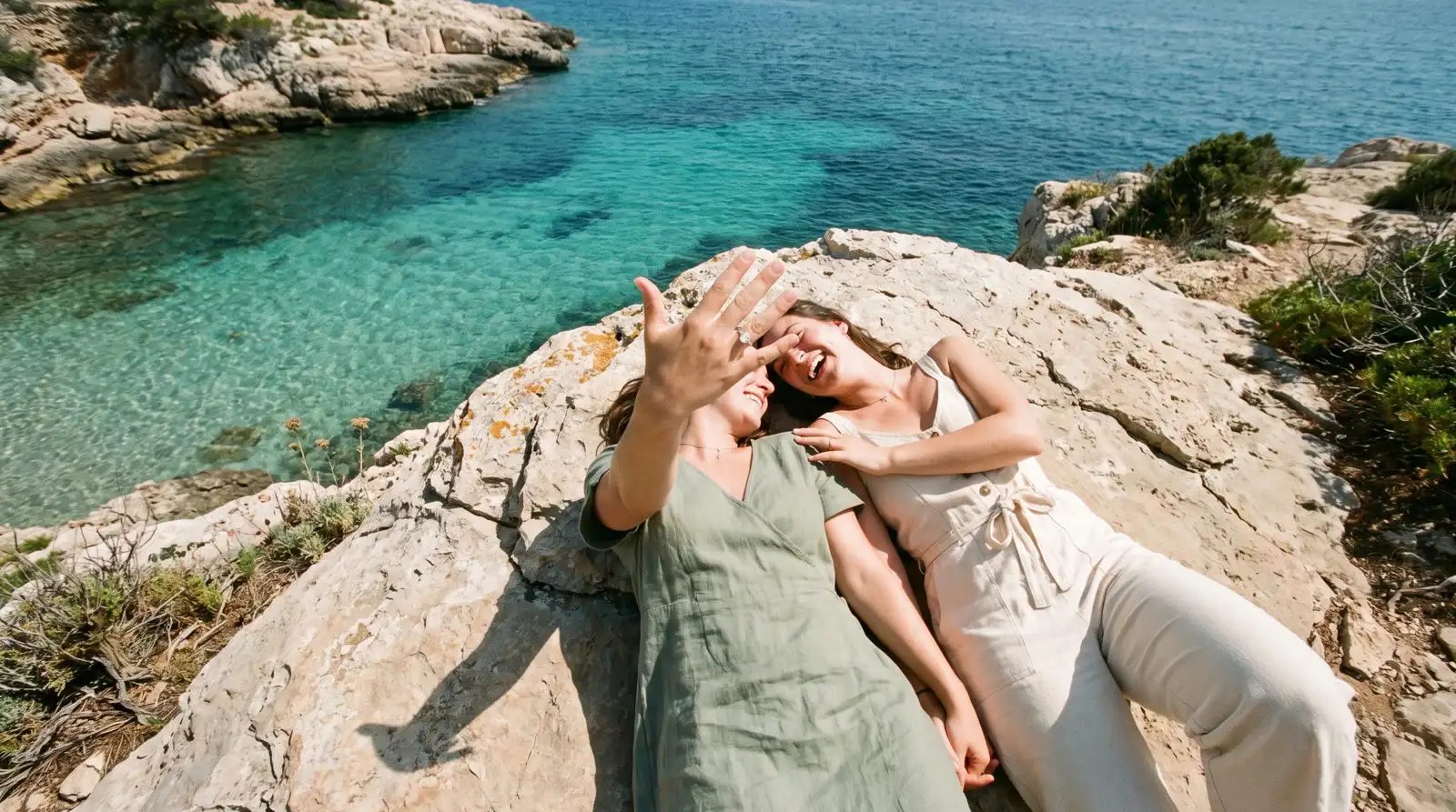 Couple at sunset on the French Riviera coastline during a proposal